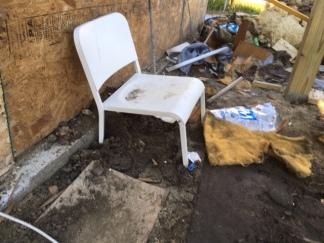 using a patio chair as a ladder